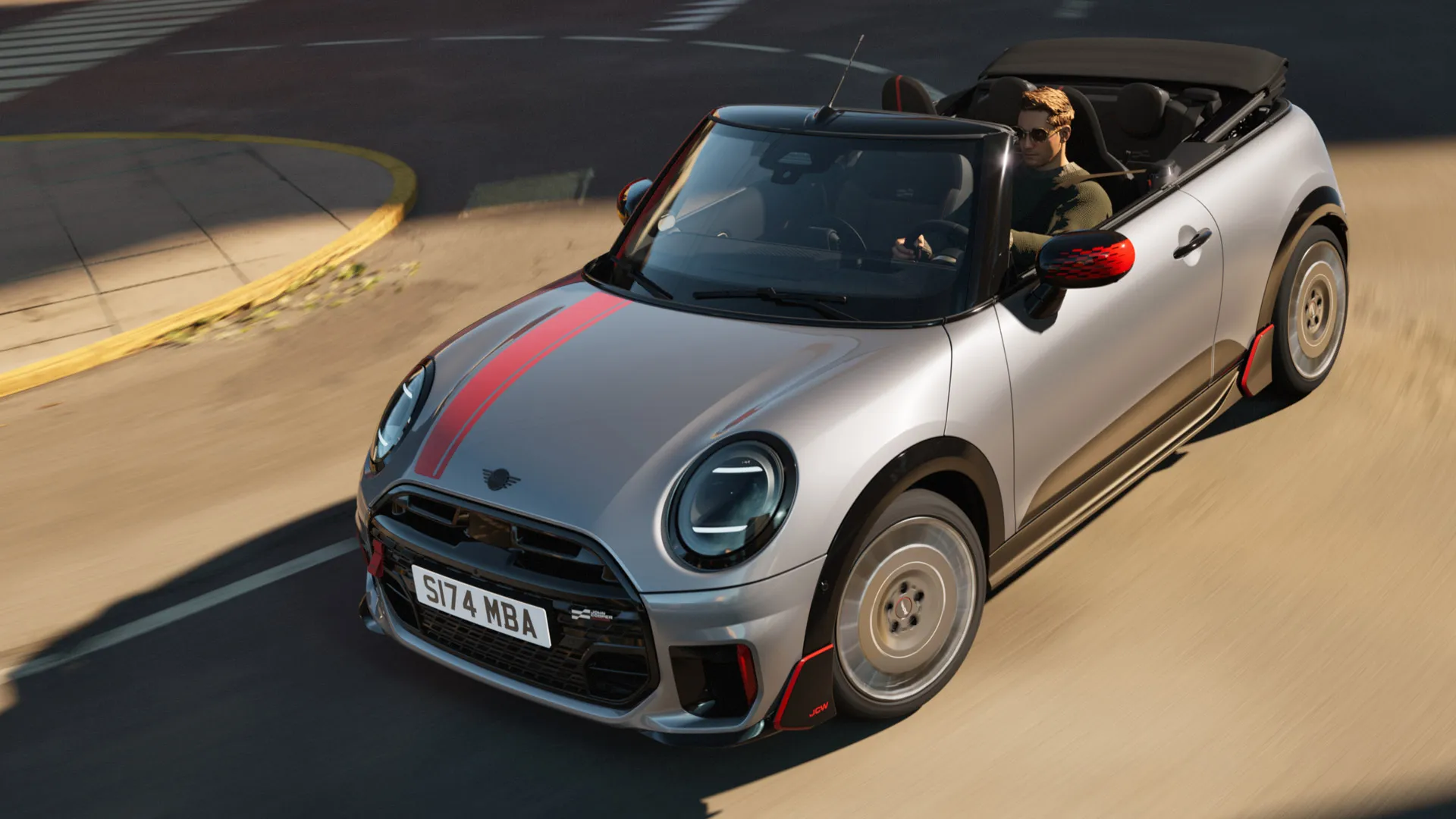 MINI kabrioleto priekinis vaizdas iš viršaus su sportiniais John Cooper Works lipdukais raudonos Chili Red spalvos.